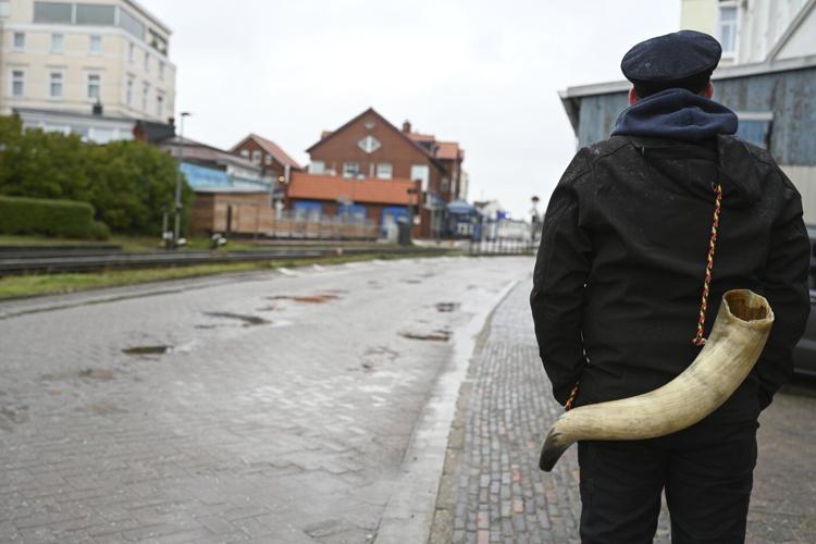 German island festival passes peacefully after criticism over practice of men hitting women