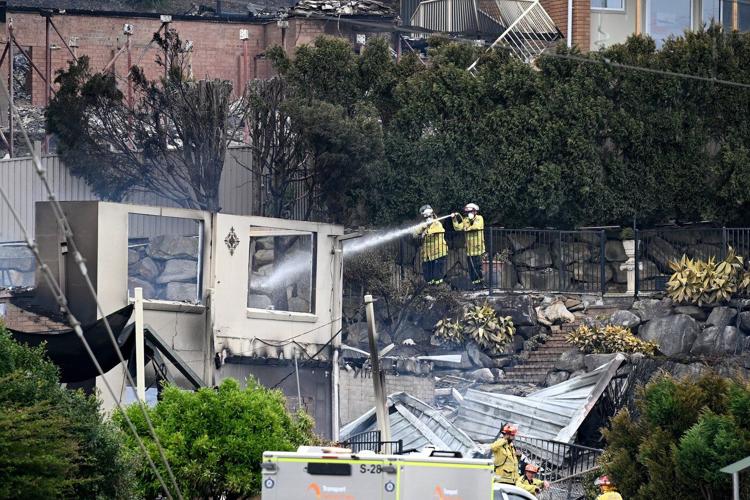 Wildfires destroy 40 homes and kill a firefighter in Australia