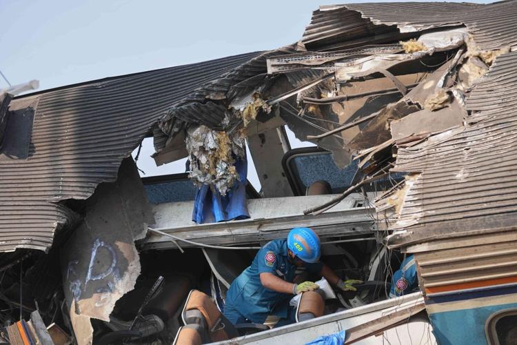 Photos show rescue workers at scene of crane collapse and train derailment in Thailand