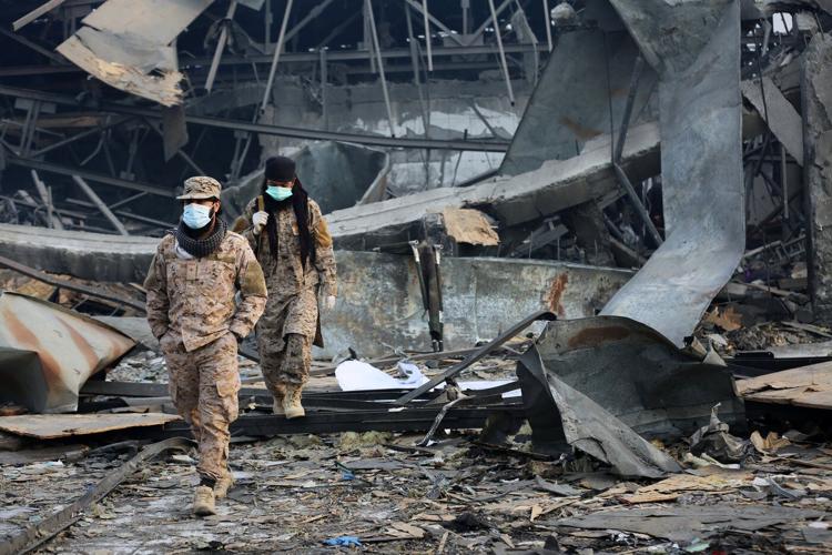 Rescue crews race through rubble after a deadly Kabul airstrike, in photos