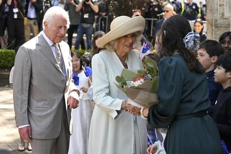 Children greet King Charles III and Queen Camilla outside a Sydney church