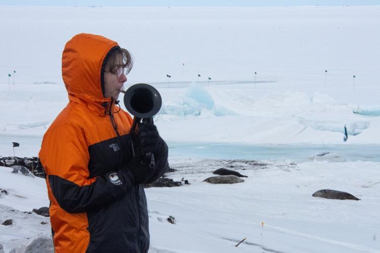 On the world’s coldest stage, a military musician plays with a plastic horn and double gloves