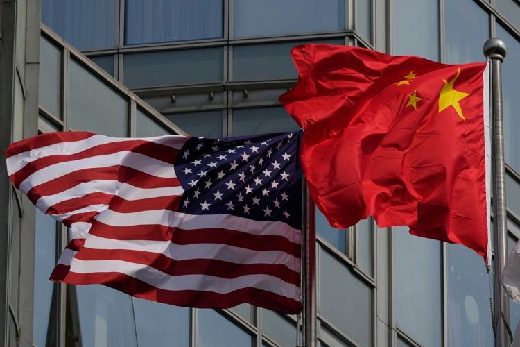 The Latest: Trump arrives in China to meet with Xi in Beijing
