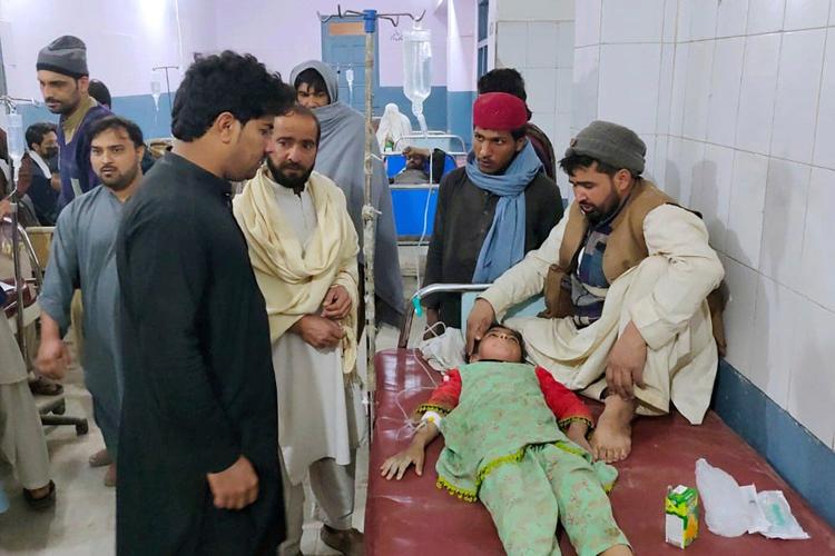 Pakistanis mourn 18 people, including 5 soldiers, killed in a twin suicide bombing at an army base