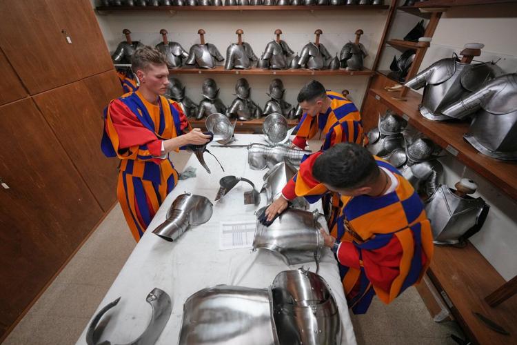 A look at Swiss Guards preparing for a swearing-in ceremony attended by the Pope, in photos