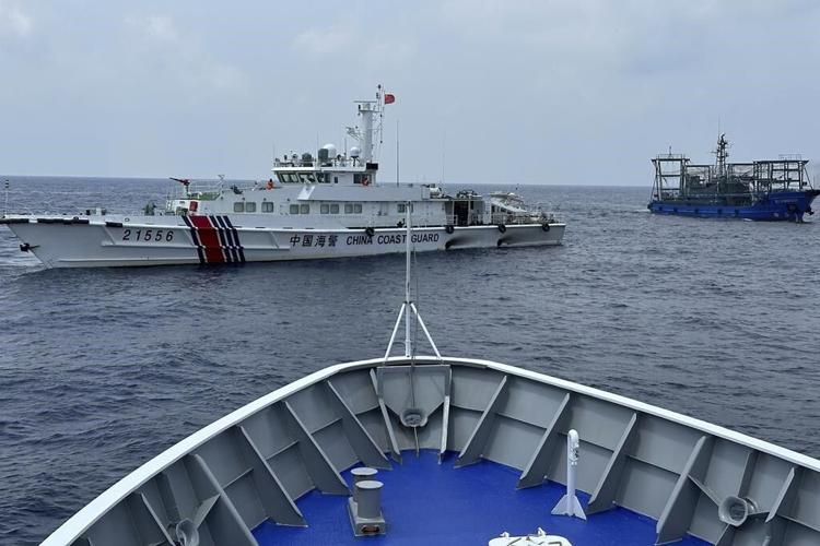 Philippines says a coast guard ship and supply boat are hit by Chinese vessels near disputed shoal