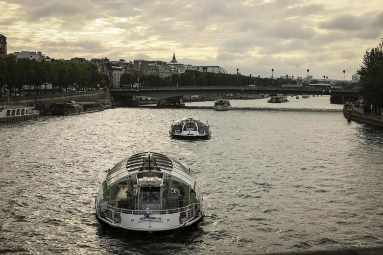 Dozens of boats cruise the Seine river in a rehearsal for the Paris Olympics’ opening ceremony