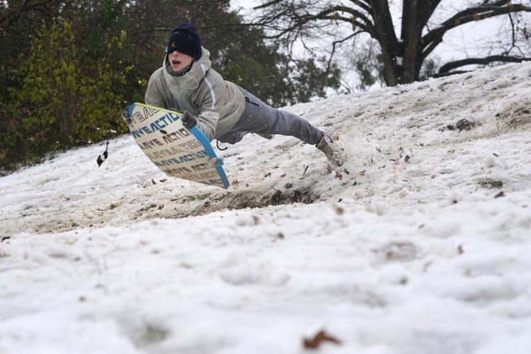 Powerful winter storm dumps heavy snow, causing flight delays, slick roads and school closings