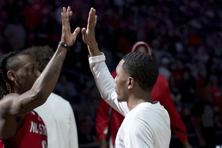 Crowns, chest bumps and swagger: In March Madness, the handshake isn't just for high fives anymore