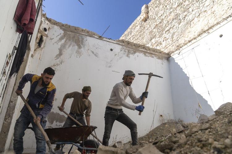 AP PHOTOS: In northern Syria, displaced owners return to houses with no roofs