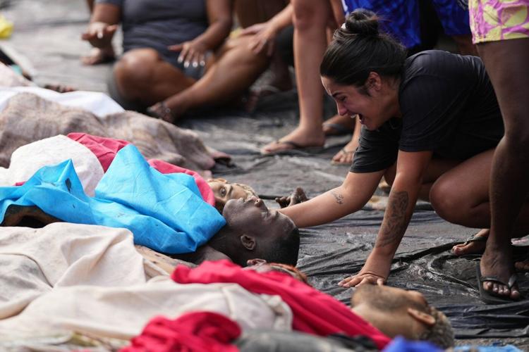 Brazilians in a Rio favela line up bodies after the city's deadliest police raid