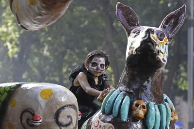 Skeleton marching bands and dancers in butterfly skirts join in Mexico City's Day of the Dead parade