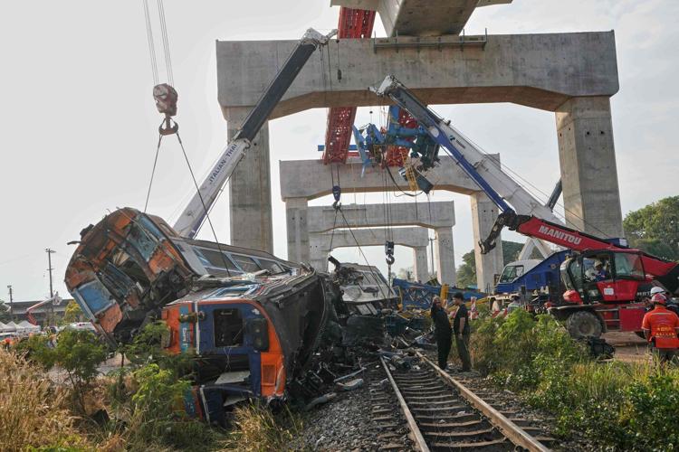 Photos show rescue workers at scene of crane collapse and train derailment in Thailand