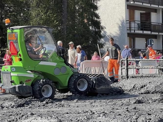 Crews clear roads after mudslide in the Italian Alps coats city streets in muck