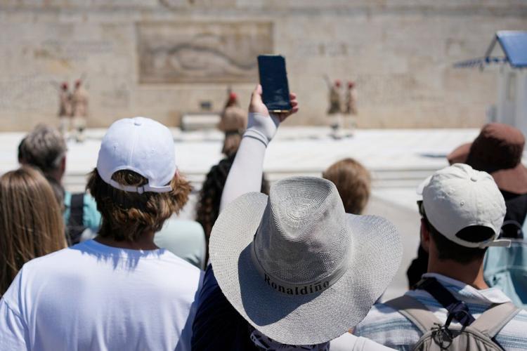 The sunhat is everywhere in Athens as crowds grow larger at ancient sites