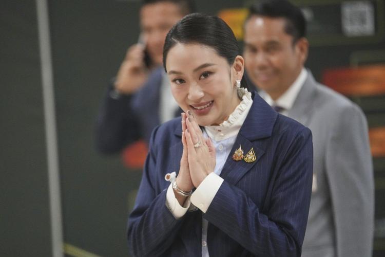 Thai prime minister survives a challenge by rivals who say her father is pulling the strings