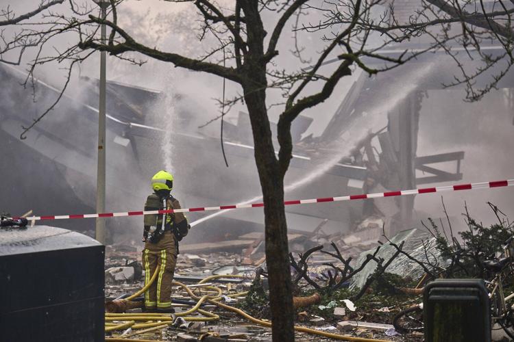 An explosion destroys an apartment block in a Dutch city, killing at least 1 and injuring others
