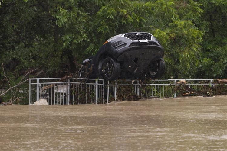 Texas flooding surges from huge rainstorms as rescuers pull people from rising waters