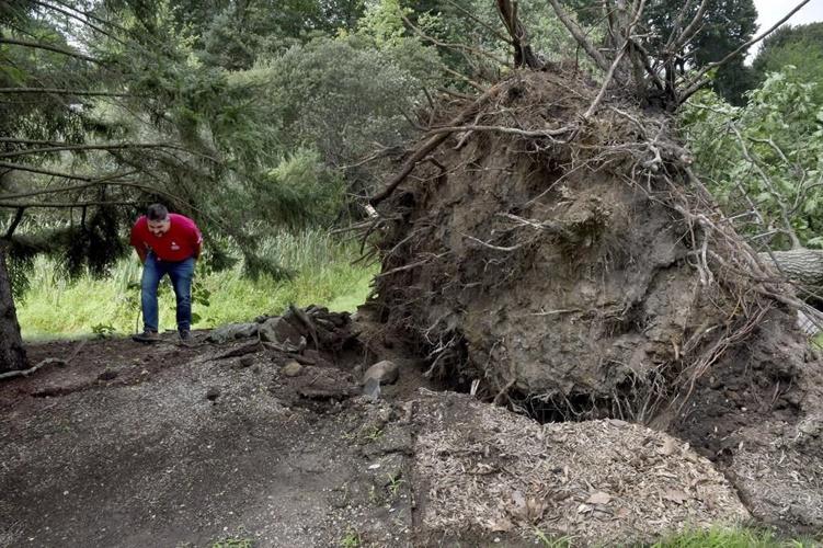 Rare New England tornado lifts car from a highway as strong storms damage homes and flood roads