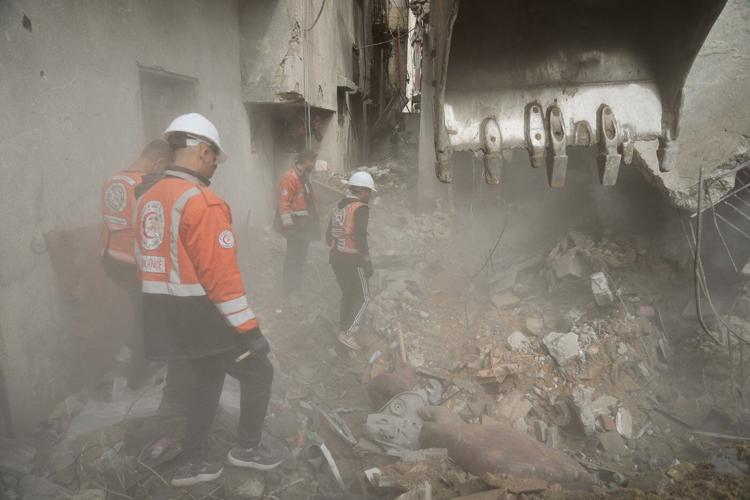 A father in Gaza searches for his family's bones in the rubble of their home