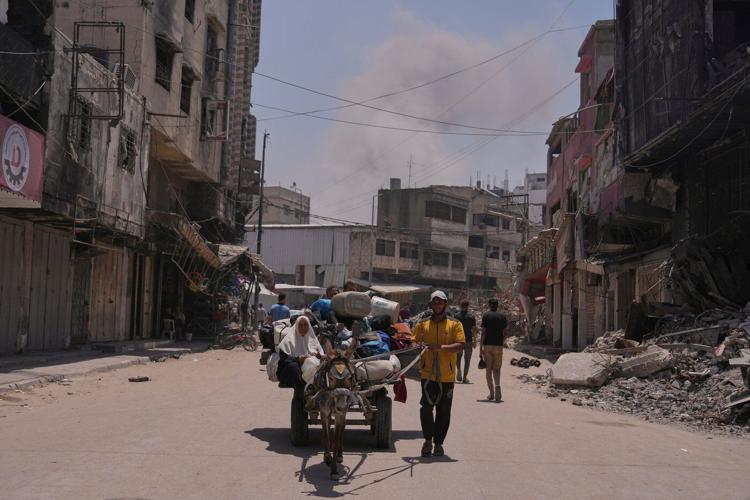 Hungry Palestinians in Gaza block and offload dozens of UN food trucks