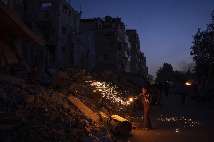 A Gaza family uprooted by war and grieving their losses shares a somber Ramadan meal in a tent