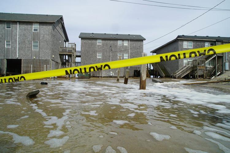 Hurricane Erin stirs up strong winds and floods part of a NC highway as it creeps up the East Coast