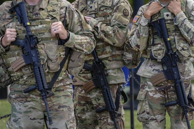 Photos of week three of Washington's federal takeover, as troops on patrol start carrying guns