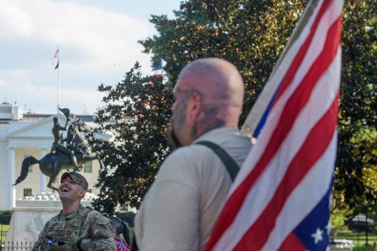 Photos of week three of Washington's federal takeover, as troops on patrol start carrying guns
