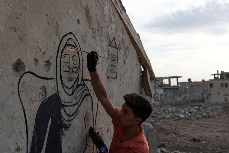 Syrian artists transform bombed-out house into a mural of remembrance, in photos