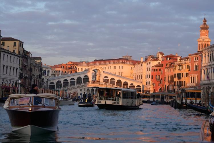 Olympic flame makes historic passage down Venice's Grand Canal