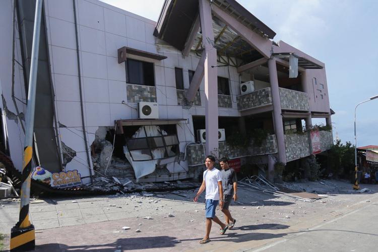 A 7.8 magnitude quake in the Philippines kills at least 32, fells buildings and sets off a tsunami