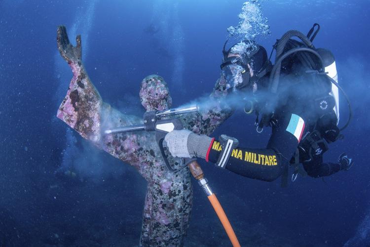 Italian divers water-blast the popular underwater statue of Christ off Portofino