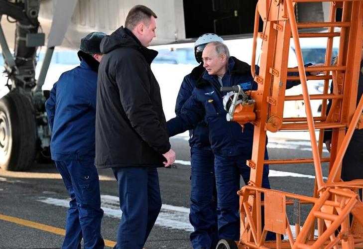 Putin takes a flight in nuclear-capable bomber in a tough message to the West ahead of election