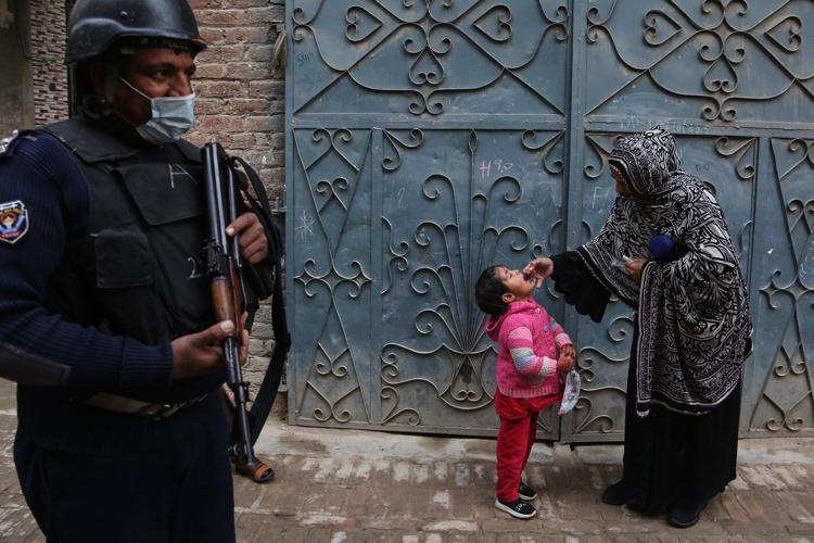 Suspected militants kill 2, including a police officer guarding polio team in northwestern Pakistan