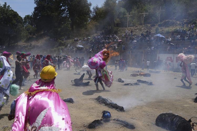 Easter is celebrated with giant caterpillar-like hats and flames in this Mexican town