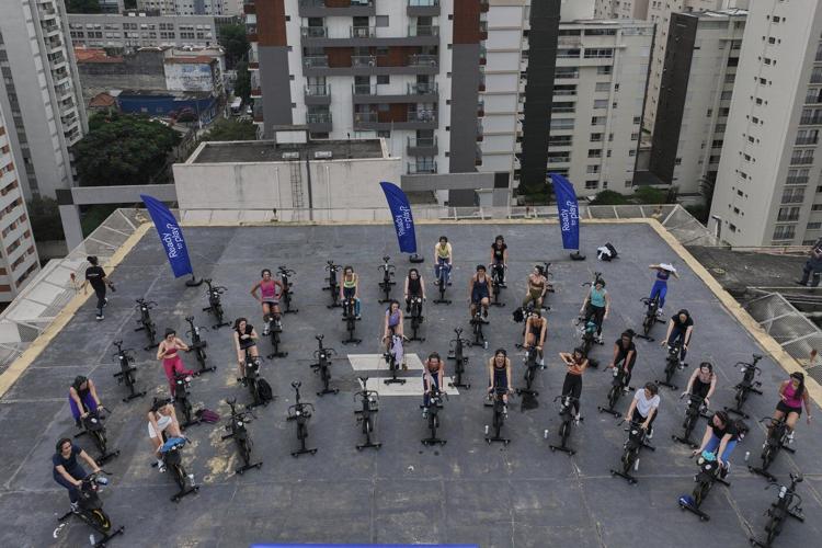 Up, up and spinning away. More Brazilians taking outdoor spin classes on helipads