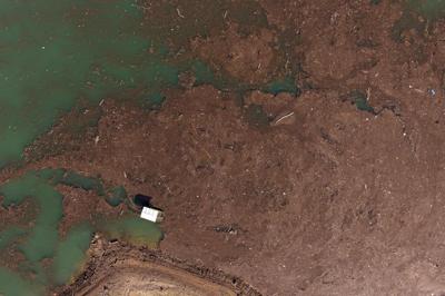 Residents and activists in central Bosnia clean up a lake after massive floods