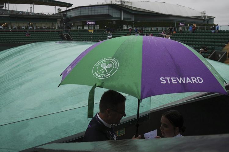 Photos show the rain on Day 3 after the Wimbledon heatwave