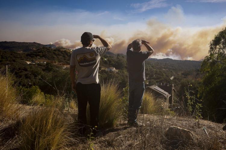 Far from wildfire flames, residents of sunny Los Angeles go about their lives in disquiet and fear