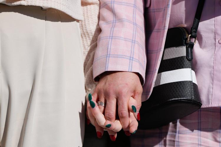 Photos of demonstrators outside the Supreme Court as it considers upholding transgender sports bans