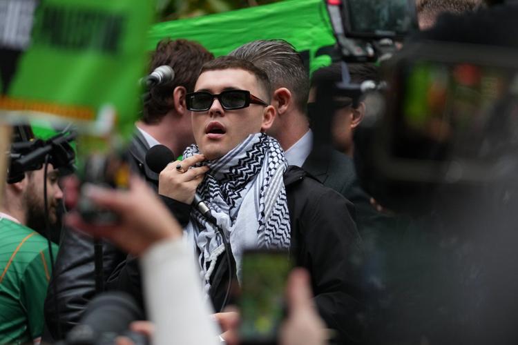 A British court throws out terror-related charge against Irish-language hip-hop group Kneecap member