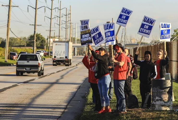 Workers strike at all 3 Detroit automakers in a battle for a bigger share of industry profits