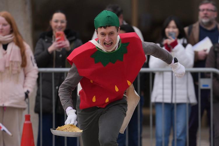 Photos of Londoners in costume sprinting with frying pans on Pancake Day