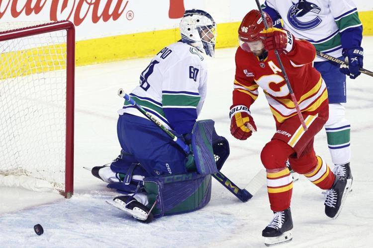 Flames ignite their offence, burn Canucks 7-3