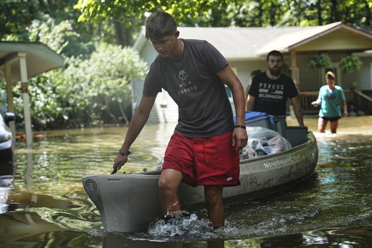 At least 6 people have died from days of storms and record-setting flooding in Indiana