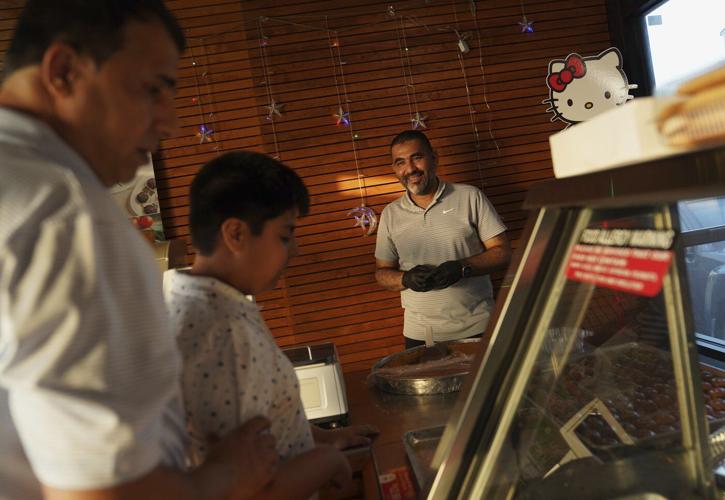 Migrants to Iowa strike different portraits where 'American Gothic' was created