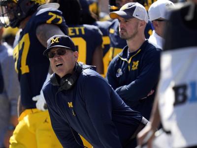 Coach Jim Harbaugh banned from 3 games over sign-stealing allegations. Michigan asks judge for stay
