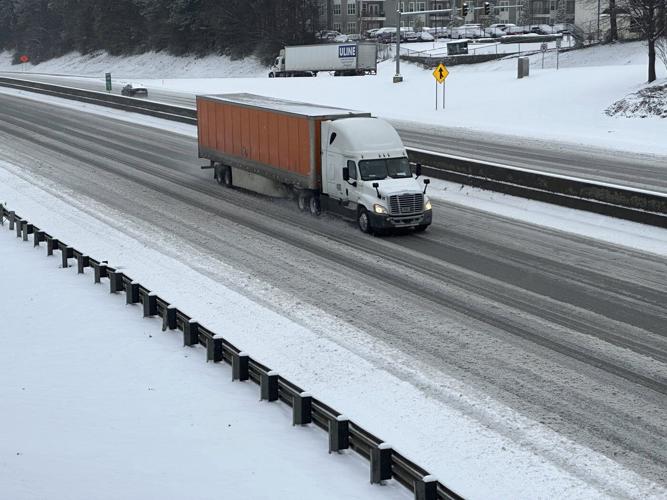 Powerful winter storm dumps heavy snow, causing flight delays, slick roads and school closings