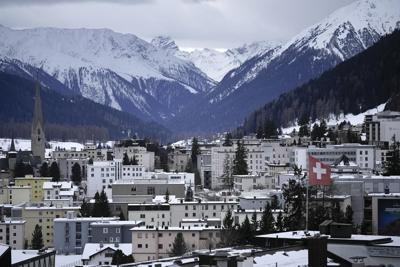 As elites arrive in Davos, conspiracy theories thrive online